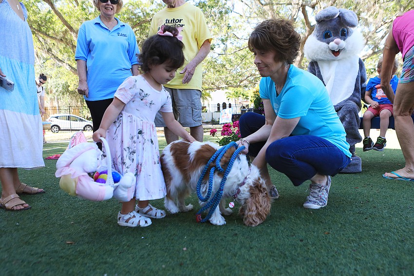 Devlyn Fischer pets Abby the dog.