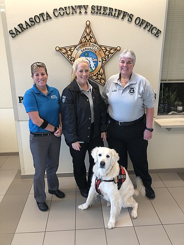 Deputy Chief Sandi Drake, Operations Managers Kristen Fitzpatrick and Pam Jones, with Hunter. (Photo courtesy of Tina Adams)