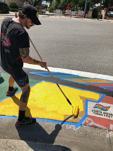 Artist Joey Salamon returns to paint the street art. (Courtesy photo)