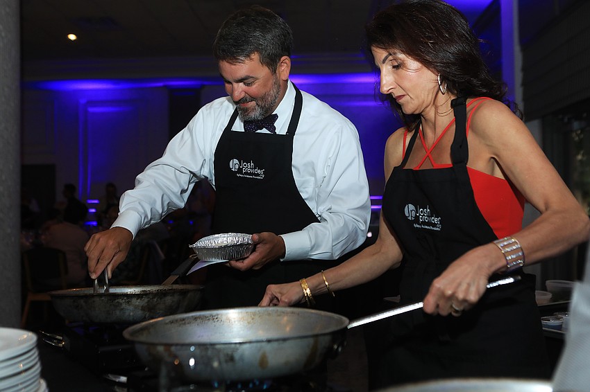 Tim Fanning and Barbara Najmy cook up food.