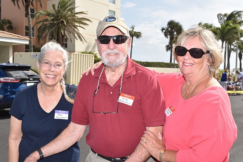 Tory Newman, Larry Bateman and Christine Filkins get ready to set up their picnic party.