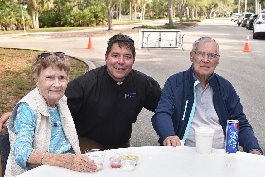 Rev. Dave Marshall, center, made the rounds to talk with attendees like CJ and Katzy Nager.