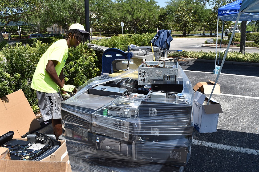 Haciendus King wraps a pallet of safe-to-recycle electronics.