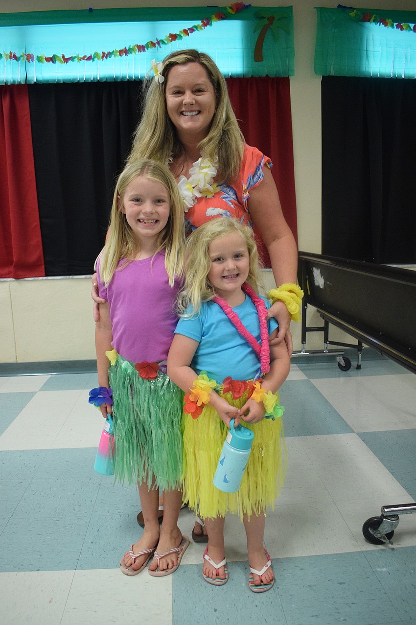 Billy Dean and her daughters Grace, who is a first grader, and Harper, who is in pre-K, go all out for the luau by wearing leis and grass skirts. 