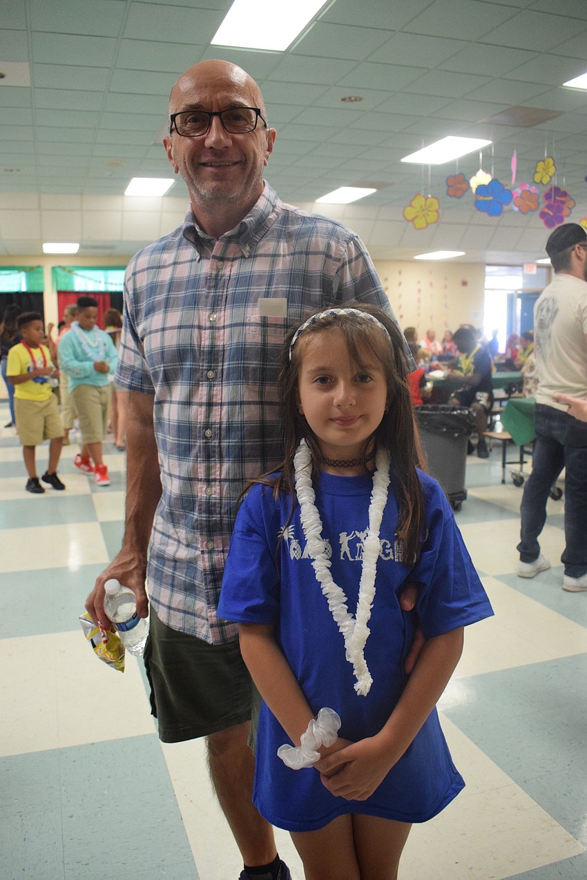 Ben Davis and his daughter, Leah Davis, who is in first grade, look forward to having a good time at the dance. Leah Davis likes to spend time with her friends outside of class.