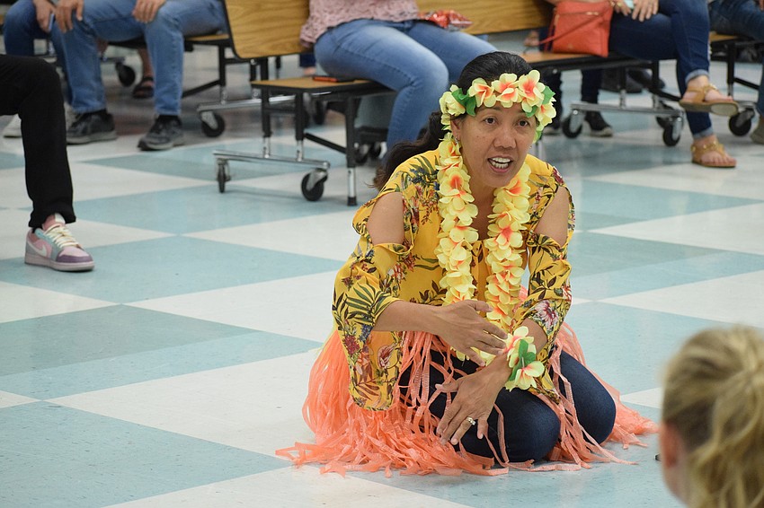 Josephine Johnson, a kindergarten teacher, leads students in a Hawaiian dance.