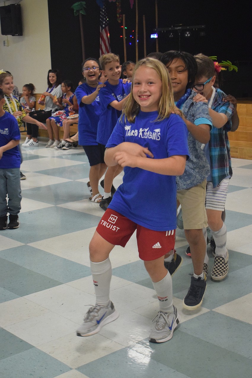 Fourth grader Morgan Baker leads students in a conga line. Baker says she enjoyed doing the conga line with friends and classmates.