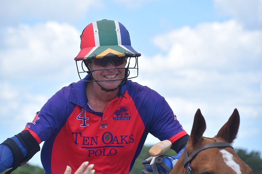 Regent's Stuart Campbell slaps high fives with the fans before the game.