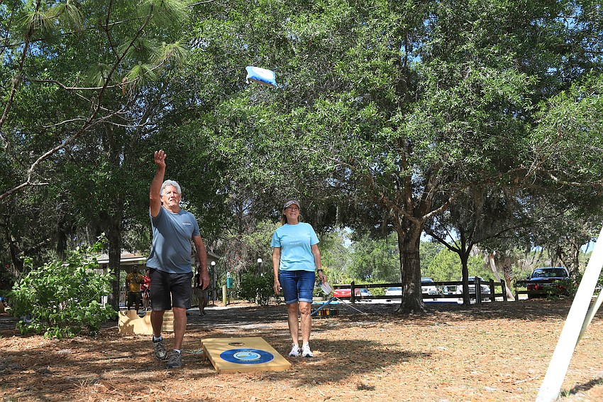 Bill and Julie Sands play cornhole.