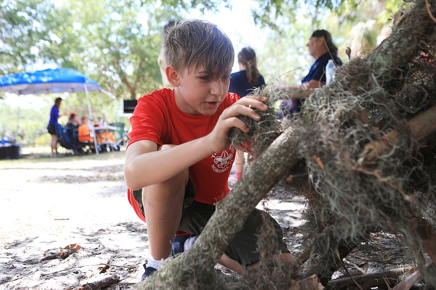 Michael Kedroff makes a tent out of moss.