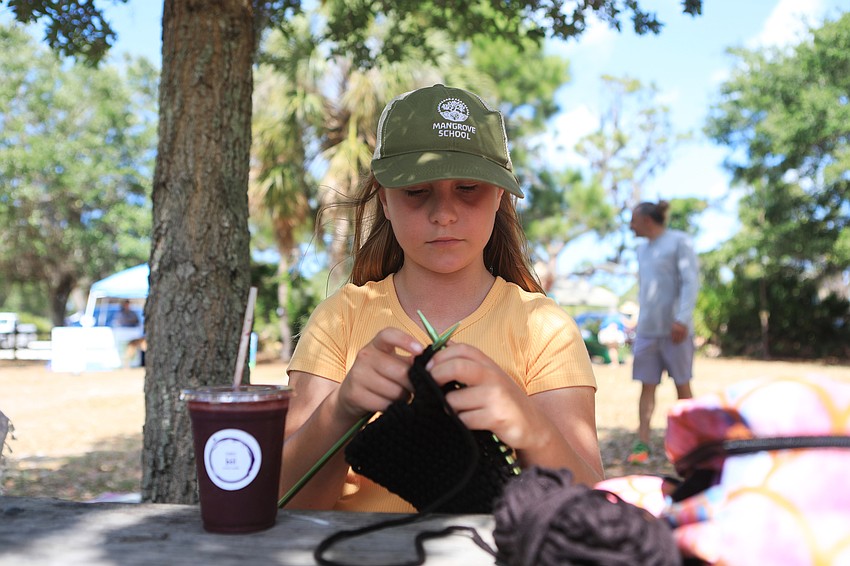 Isla Schroeder knits in the shade.