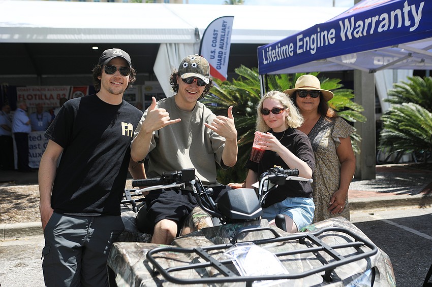 Collin and Sean McCaffrey, Romy Ferland and Debbie McCaffrey check out vehicles.