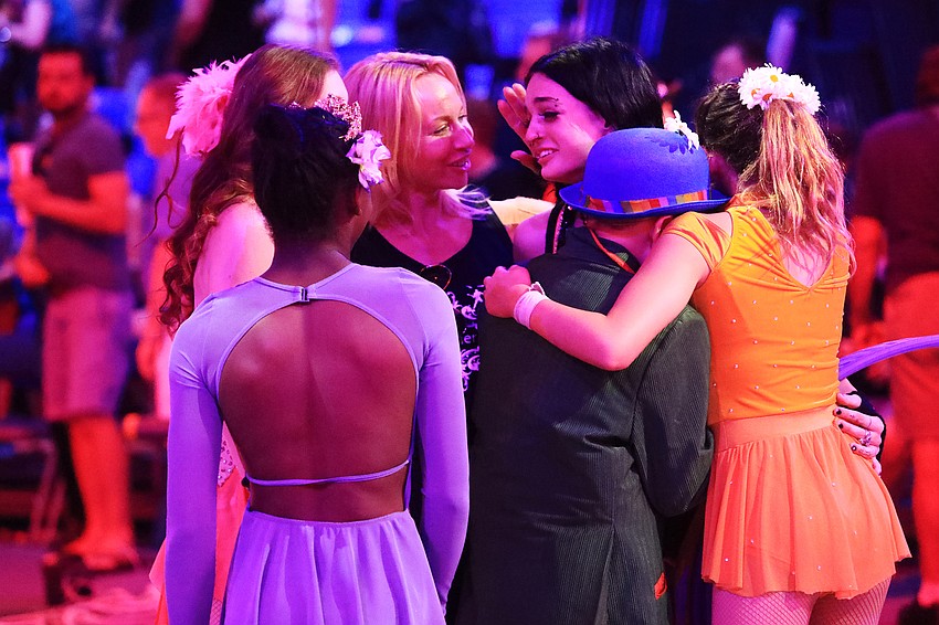 Coach Olga Coronas consoles her students.