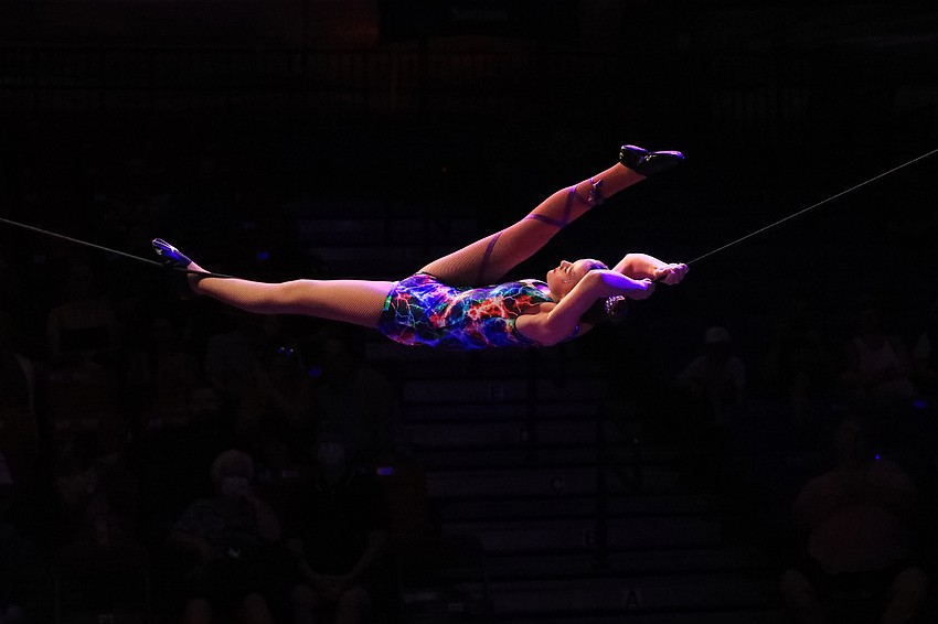 Destiny Overholt hangs from a wire.