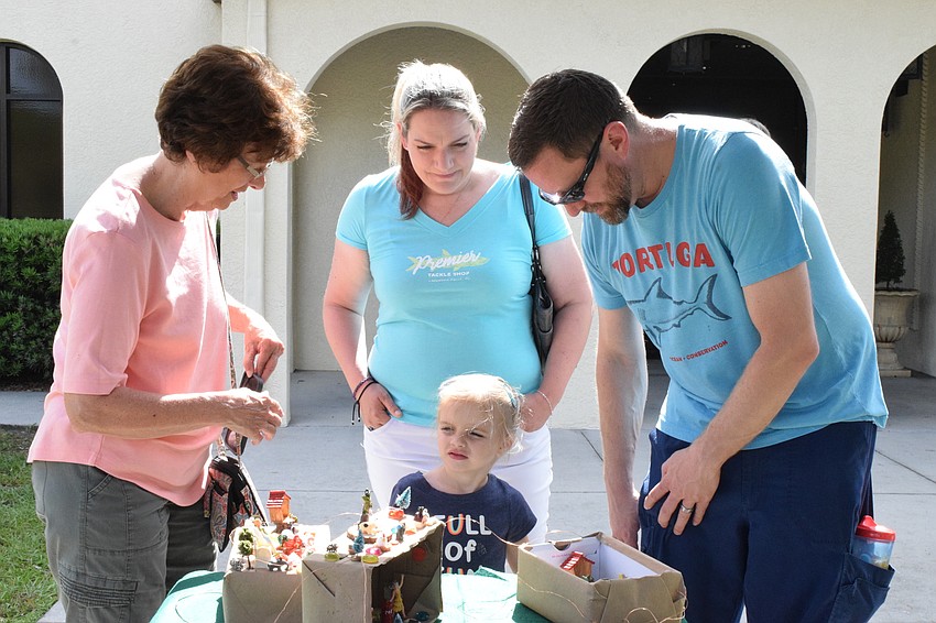 Lakewood Ranch's Beverly Hill, Jessica Hill and Jim Hill listen to Kali Hill, a World of Wonder Academy student, explain the fairy garden she created.