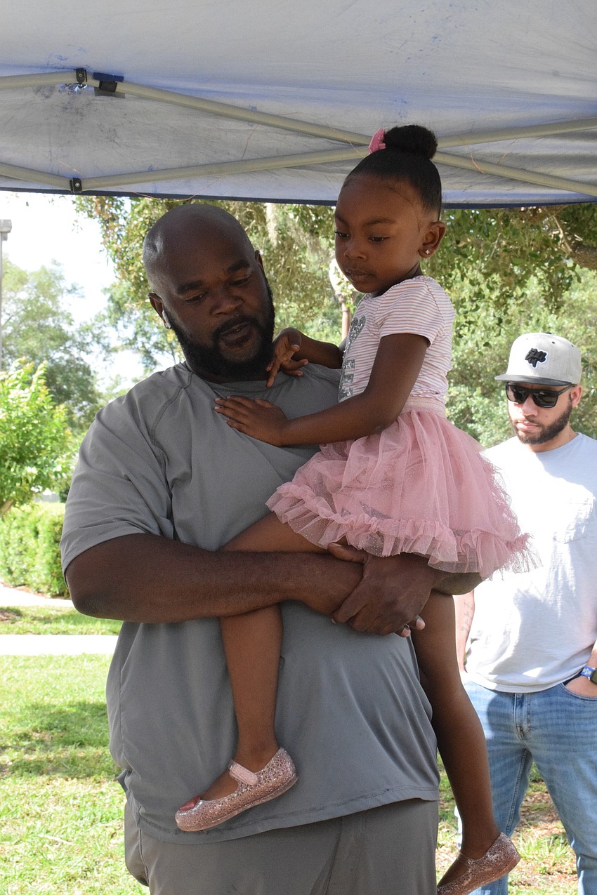 Lakewood Ranch's Kareem Claxton holds onto his daughter Kristina Claxton while she talks about her art projects.