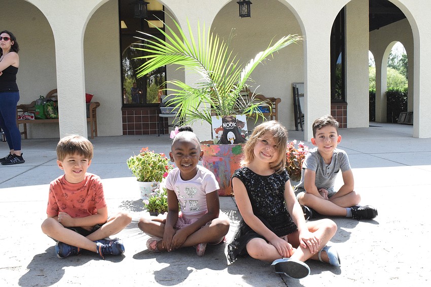 Liam Byrne, Kristina Claxton, Hope Fisher and Jeremy Gilkey are proud of the flower pot they painted together one week to go along with the theme of teamwork.