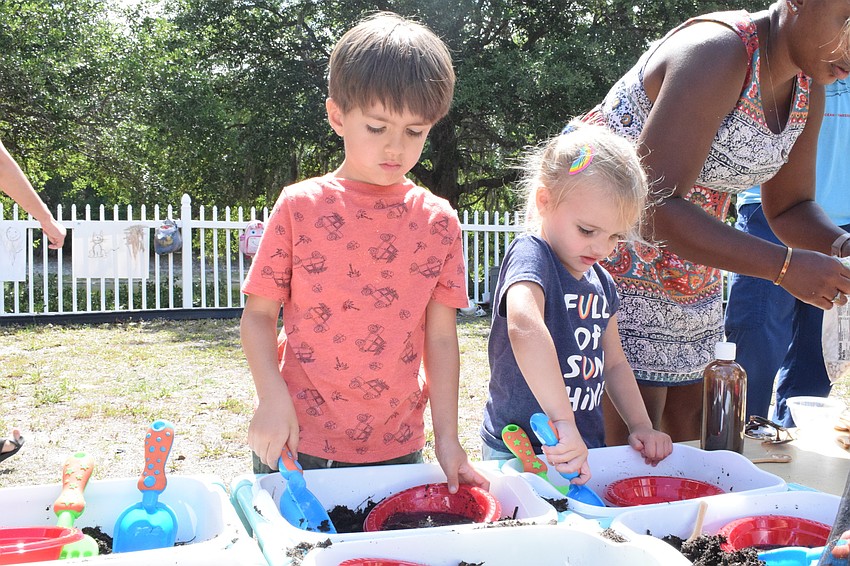 Mote Ranch's Liam Byrne and Lakewood Ranch's Kali Hill work on making their own mud pies. Heather Manley, a leader of World of Wonder Academy, says Hill loves to mix things.