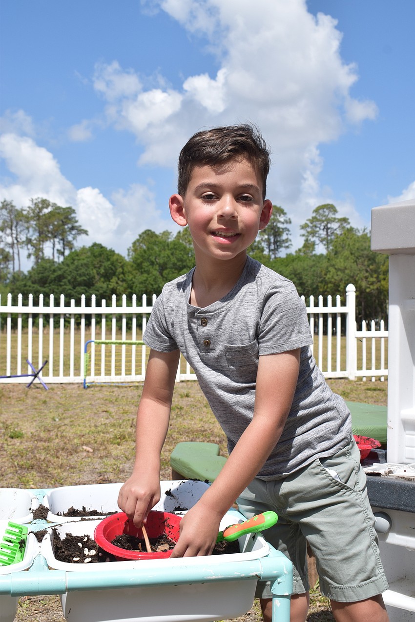 Jeremy Gilkey makes a mud pie. Gilkey added grass and leaves to his mud pie as well.
