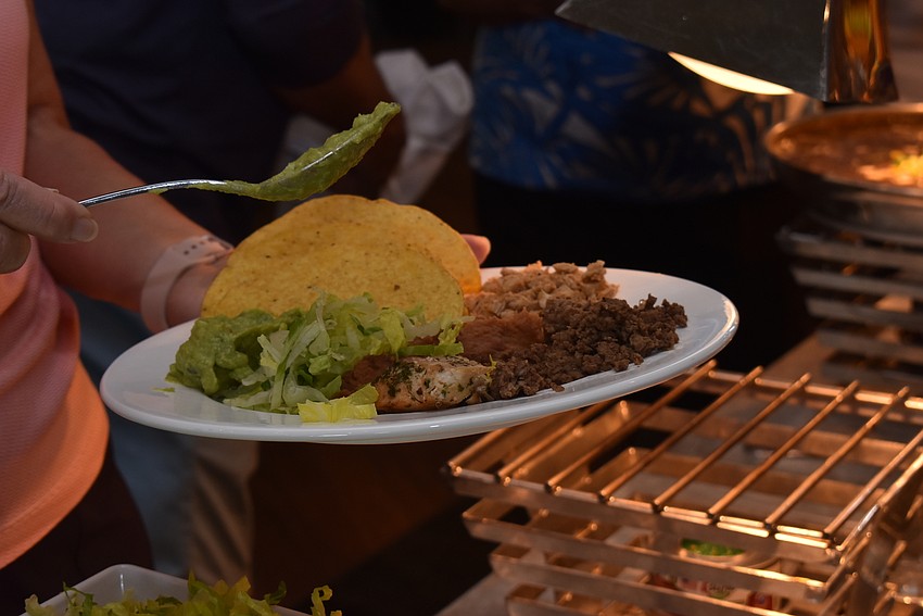 Attendees loaded up their plates with tacos.