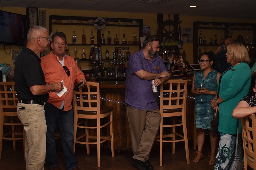 Attendees mingled around the bar.