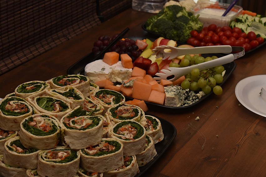 Attendees grabbed light bites from a table.