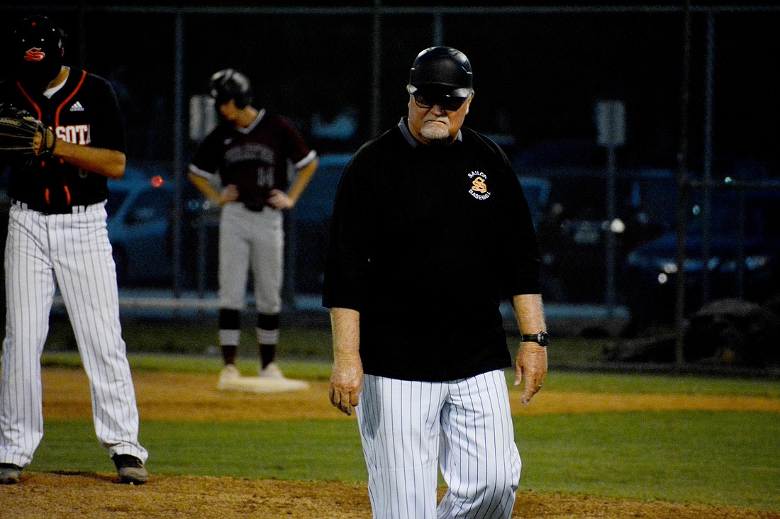 Sarasota High Coach Clyde Metcalf walks off the field after giving Sailors senior pitcher Conner Stewart some advice. Metcalf, the program&#39;s coach since 1982, said he is still having fun every night with the team.