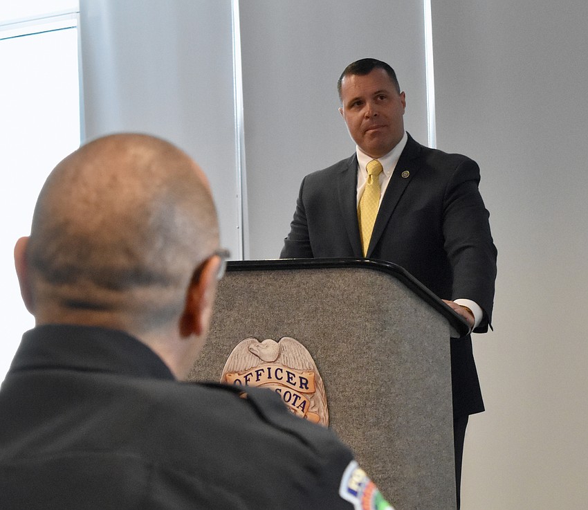 Deputy City Manager Pat Robinson welcomes guests to the swearing-in ceremony for Chief Rex Troche at Sarasota Police Department headquarters.