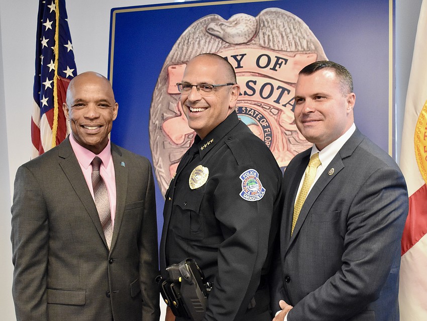 City Manager Marlon Brown,  Chief Rex Troche and Deputy City Manager Pat Robinson  pose for photos after the ceremony.