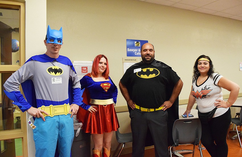 Braden River Elementary School parents Corey Menett, Chantel  Kinyon, John Turner and Yajaira Delgado dress as superheroes during students' lunch periods.