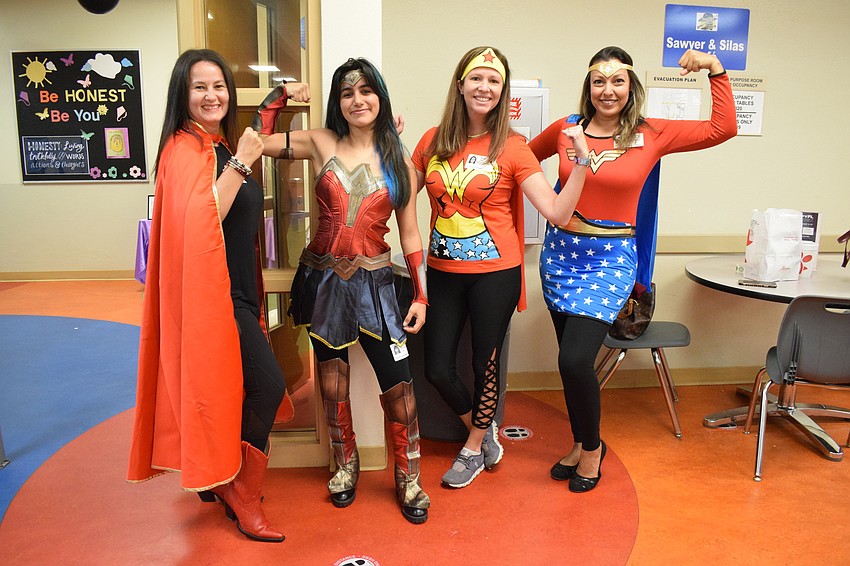 Tunde Szekely, Barbara Baeza, Mandi Nehring and Melanie Hayes Petty all dress as Wonder Woman for Superhero Day. Baeza says students can connect with superheroes and find them inspiring.
