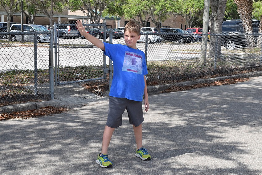 Fifth grader Brady Colcu works to stop traffic during a demonstration on what to do when there is an accident.