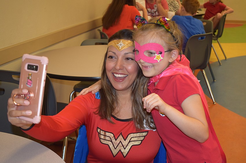 Melanie Hayes Petty takes a selfie with her daughter Colette Petty, a first grader, on Superhero Day at Braden River Elementary.