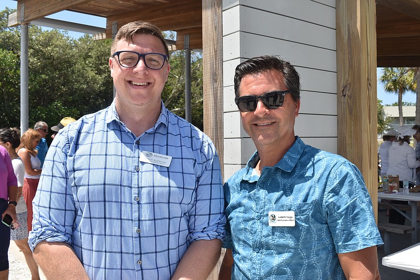 Travis Barrows from the Boys and Girls Clubs and Aaron Virgin from Save Our Seabirds wait for lunch.