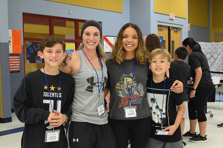 Fourth grader Clayton Upshaw and his mother, Ashley Upshaw, and Bianca Highsmith and her fourth grader Mason Marston have fun at the Olympics. Clayton Upshaw and Mason Marston were most excited to play soccer.