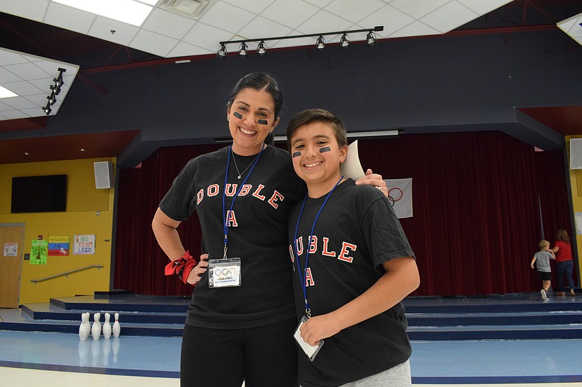 Angie Mooer and her fifth grader Aiden Moore match in team shirts. They came up with the name 