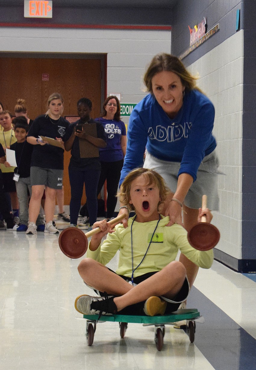 Candice Smith pushes her son Bowen Smith, who is in fourth grade, during bobsledding.