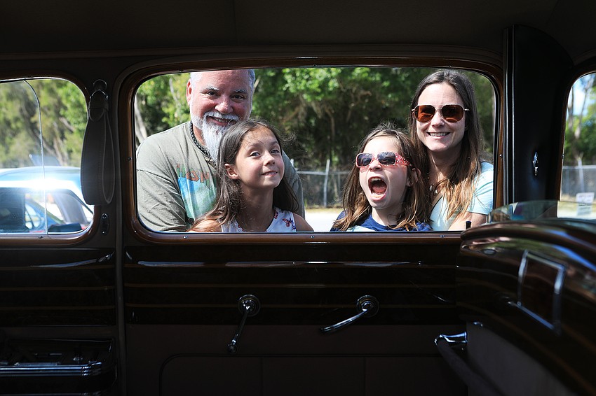 David Steele, Ally Danforth, Stephanie Varacskay and Kaylee Varacskay check out a car.