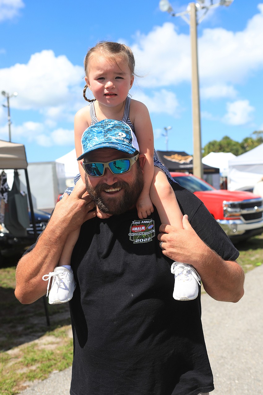Everleigh Beauchamp sits on her dad Mark Beauchamp's shoulders.