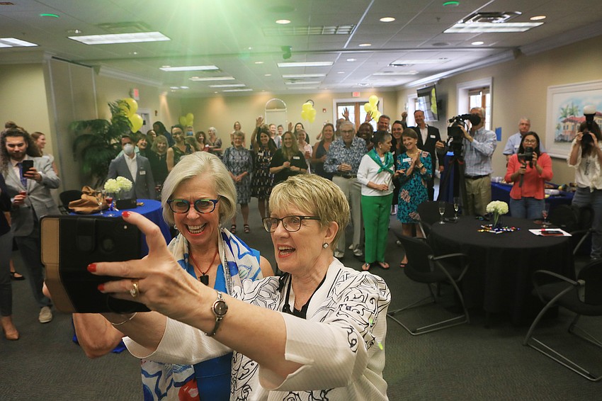 Roxie Jerde and Debra Jacobs welcome the audience.