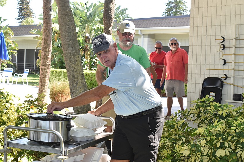 Dan Miller wheels food over to the party.