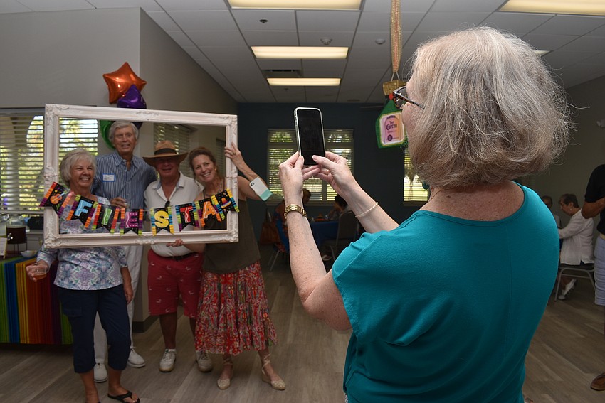 Mary Ann Brady snaps a photo of Barbara Koetsier, Dick Pelton, Lenny Landau and Suzy Brenner.