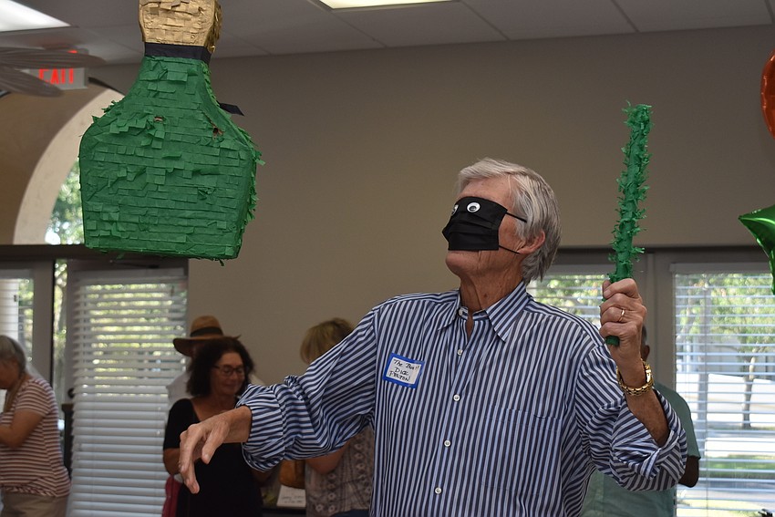 Dick Pelton takes a swing at the piñata.