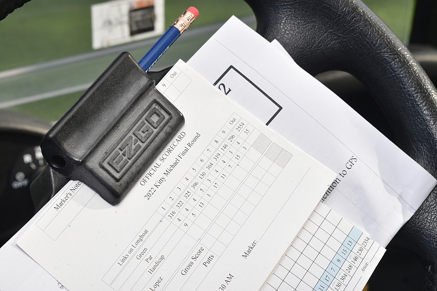 The golfers kept their scorecards close.