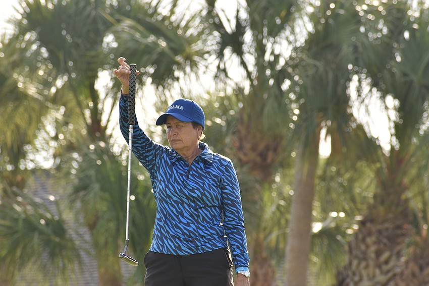 Mayita Alfaro lines up a putt.