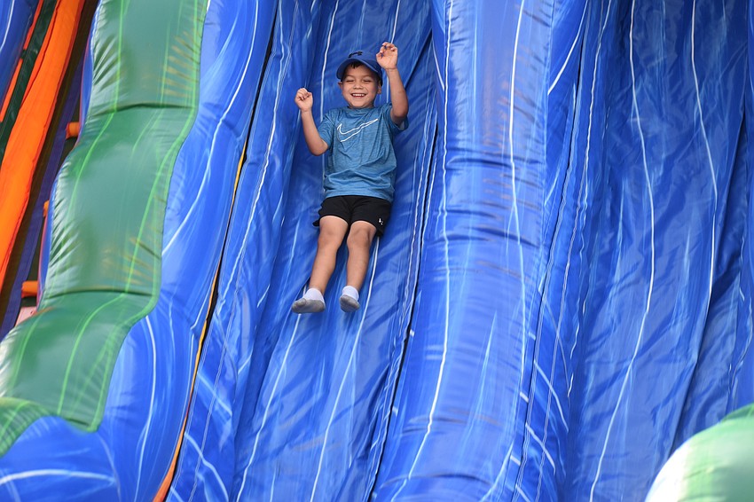 Sarasota's Logan Marquez, 5, braves the inflatable slide.