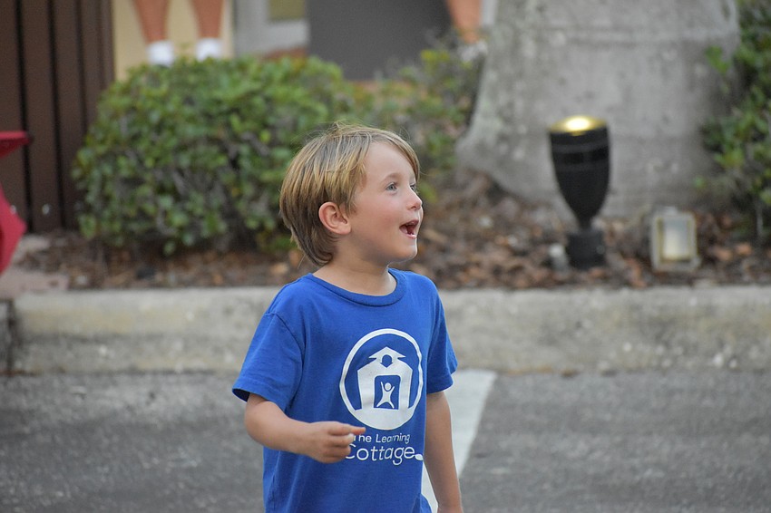Cameron Varona, 5, runs toward the stage to after the band finishes a song.