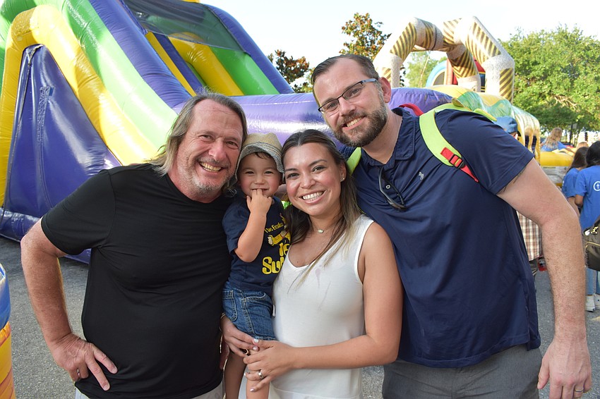 Lakewood Ranch's Tim Mildren makes his first visit to Music on Main, with his neighbors Bennett, Bridget, and Tim Prichard.