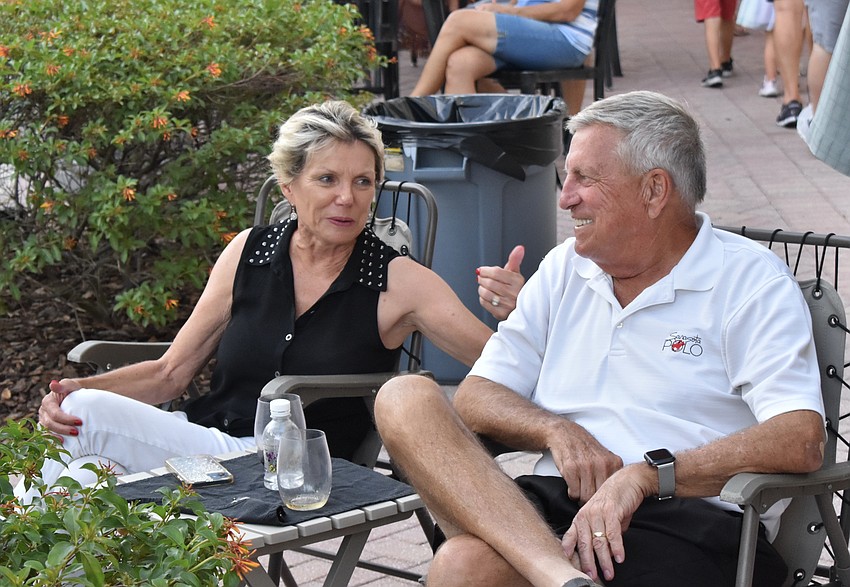 Donna and Larry Euston of Boca Grove watch the performance. The couple, who come to Music on Main every month, say the band is 