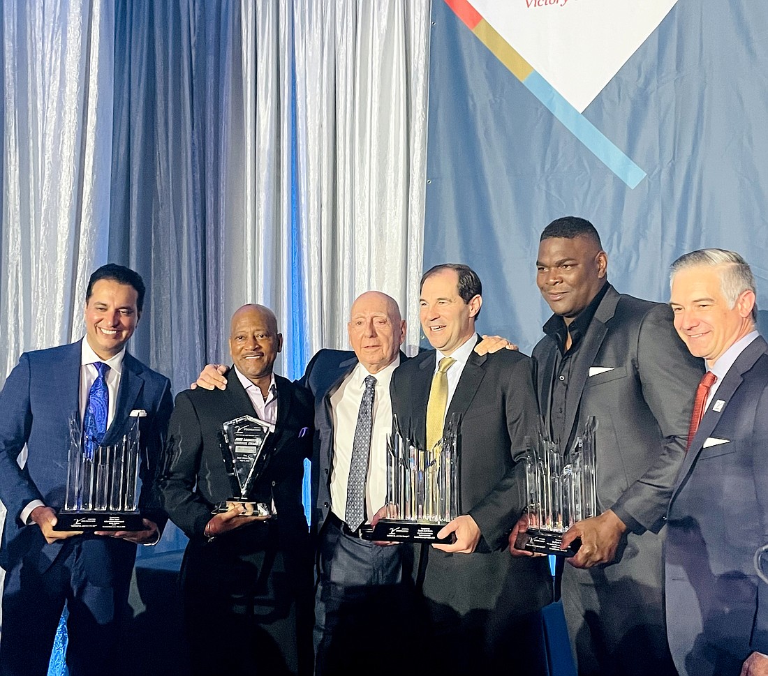 Kevin Negandhi, Rod Gilmore, Dick Vitale, Scott Drew, Keyshawn Johnson and V Foundation CEO Shane Jacobson stand together at the Dick Vitale Gala. The 2022 gala raised $11.1 million for the V Foundation, an event record.